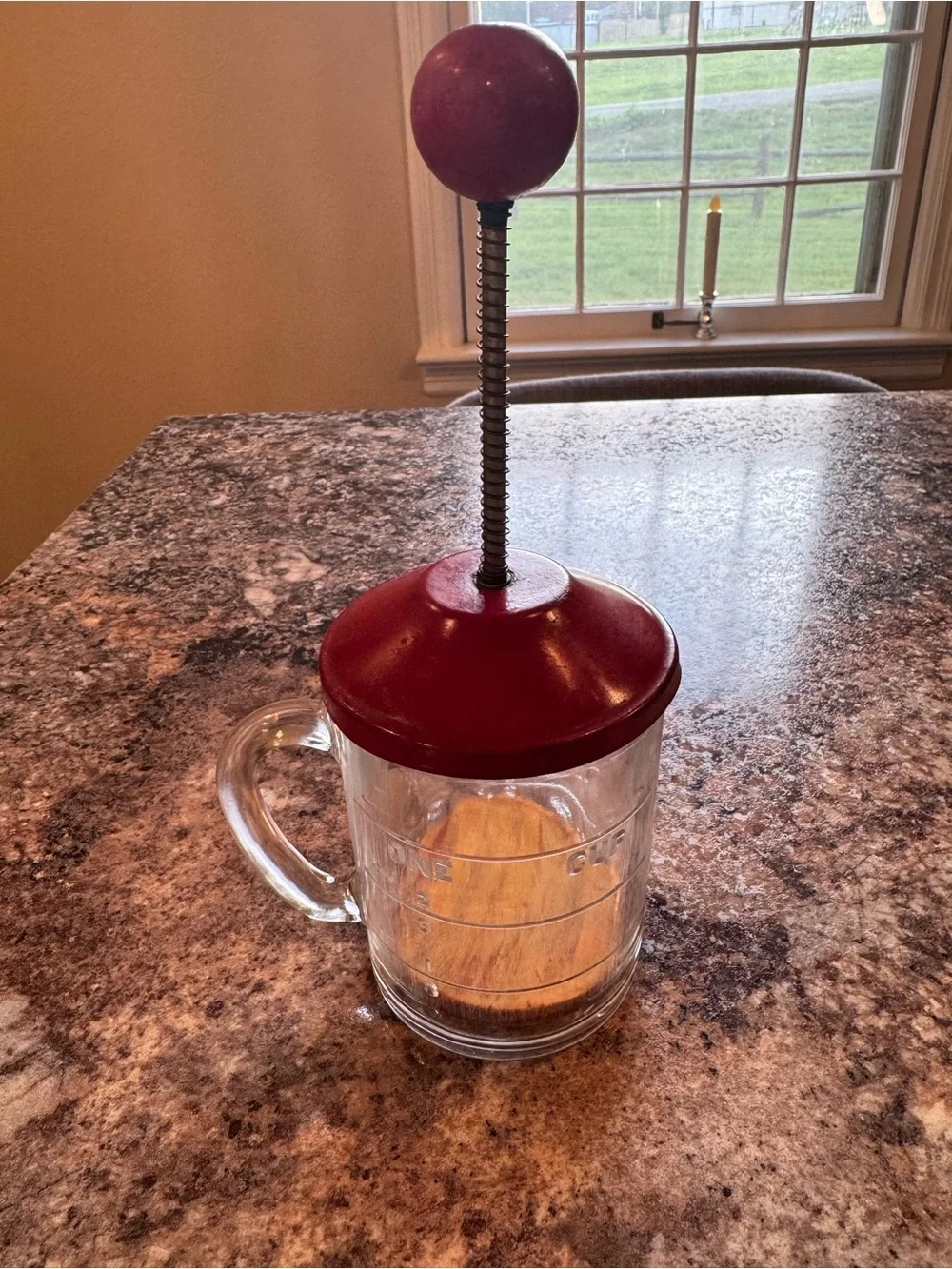 Vintage Hazel Atlas glass kitchen chopper with red lid and ball handle